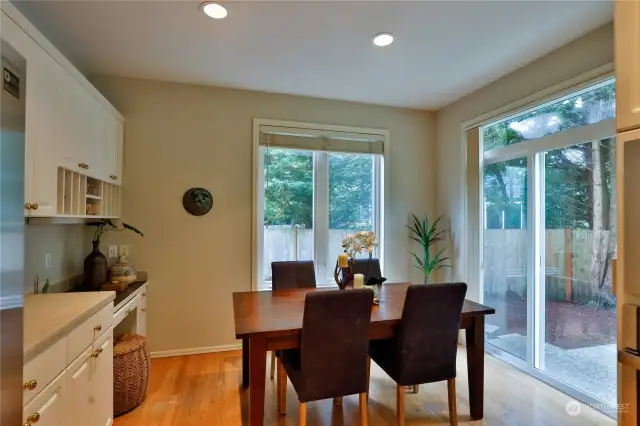 Cozy breakfast nook off Kitchen has built-in cabinetry and desk, plus sliding door access to Back Yard!
