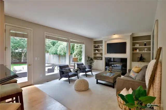 Cheerful Family Room with gas fireplace, built-in bookshelves!