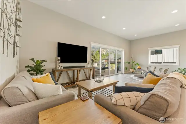 View 2 of the living room looking towards the seating area & glass sliding doors leading to the large lake view deck.