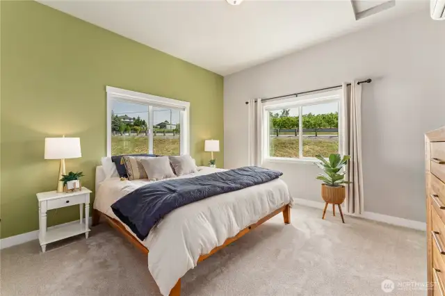 View 1 of the upper level Primary Bedroom suite w/ oversized windows & mirrored closet doors.