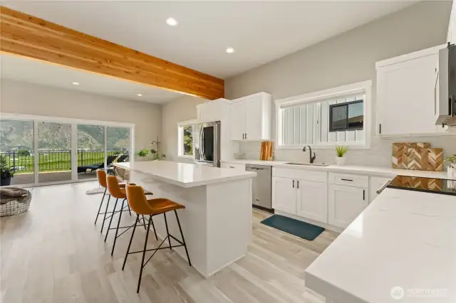View 2 of kitchen w/ high-end appliances, quartz countertops & sit up bar.