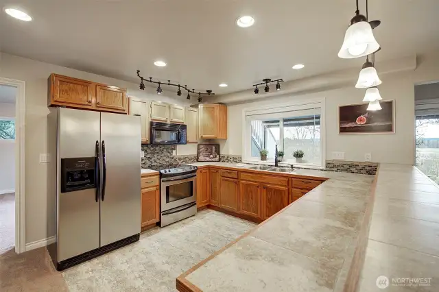 Daylight basement has full sized kitchen with raised bar top. All appliances stay!