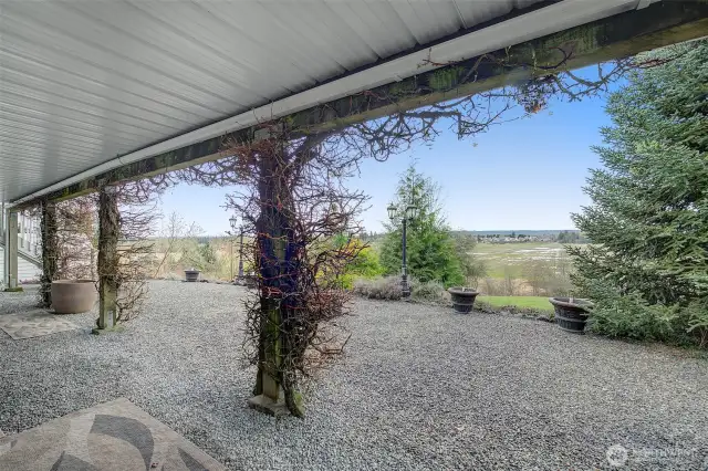 Lower level gravel patio has a fire pit and tons of space to play