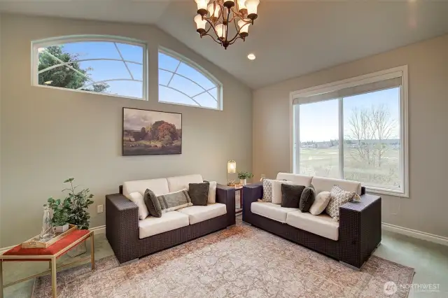 Second living space off the kitchen has French doors leading out to the covered front porch. This room could also be used as a formal dining room