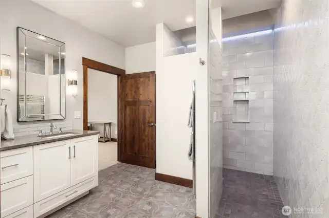 Luxurious primary bath with walk-in tile shower,