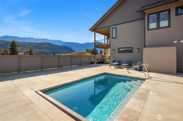 Beautiful pool with stair & sitting bench and access to outdoor shower.