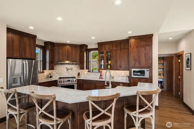 1/2 bath off kitchen and large walk-in pantry with custom cabinetry