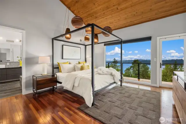The primary bedroom is a true oasis, featuring rich hardwood floors, floor-to-ceiling windows, and a private balcony.