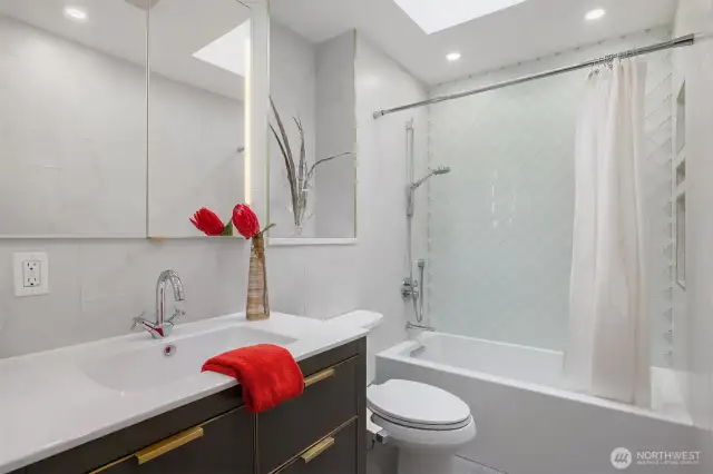 The en-suite bathroom offers luxurious heated floors and a sleek glass-tiled shower—combining comfort with modern elegance.