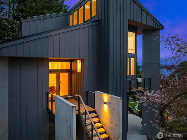 The home's modern design thoughtfully integrates windows and skylights throughout, filling each space with natural light.