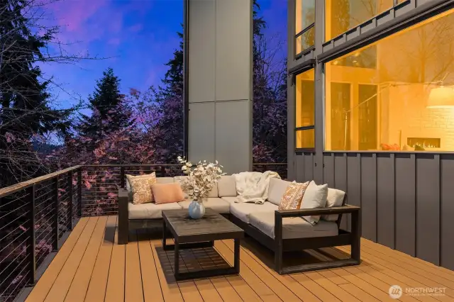 The expansive deck offers multiple entertaining spaces, including this one located in front of the living room.