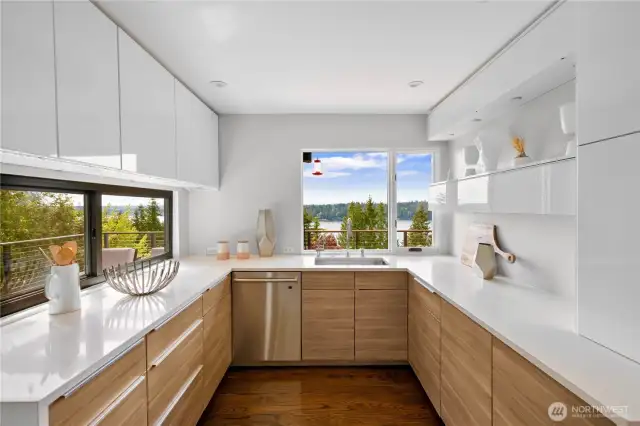 Bright, spacious kitchen featuring generous counter space and a convenient pass-through window to the side deck—perfect for seamless indoor-outdoor entertaining.