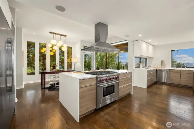 A premium Wolf range, oven, and hood on a generously sized island, with ample space for cooking and prepping all around.