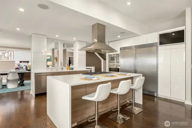 A full-sized refrigerator and freezer provide ample storage for daily living and entertaining, while the island offers additional seating and built-in storage.