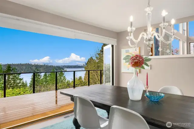 An entertainer’s dream—this stunning dining room features folding glass doors for effortless indoor-outdoor living and unforgettable gatherings. Full-size automated awning outside the dining room blocks the afternoon sun.