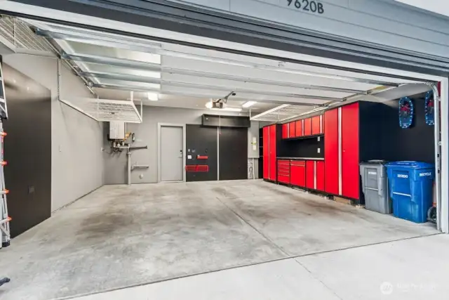 An organized garage! built in work space, cabinets and hanging racks/hooks