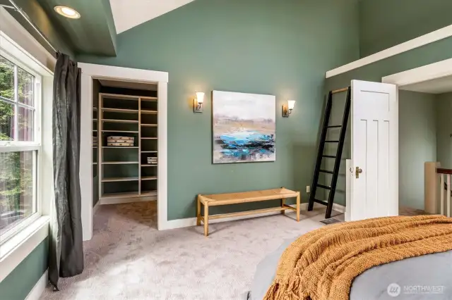 Bedroom with large walk in closet with built in shelving.