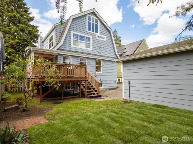 Backyard with view of the deck and back of the house.