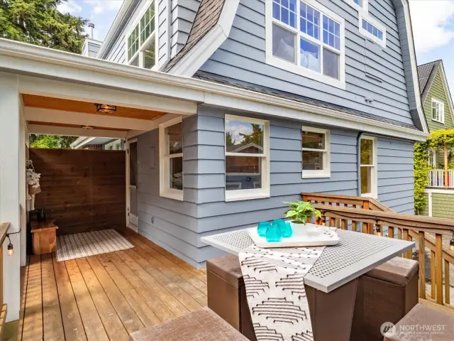 Deck and covered back entrance leading into the kitchen.