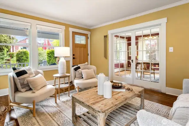 Living room with the dining room beyond glass doors.