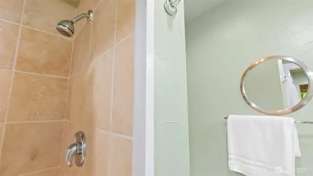 The primary ensuite also showcases sleek chrome fixtures for a clean, modern finish.