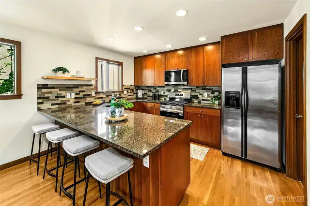 Kitchen has lots of counter space including room for at least 4 stools