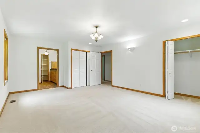 Another view of the primary bedroom highlights its generous size and versatile layout, offering plenty of space to relax and personalize.
