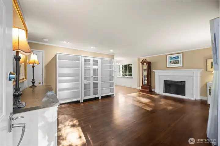 Spacious living room with beautiful oak hardwood floors, lots of natural light & fireplace.