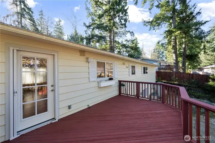 Large deck off the dining room overlooks beautiful, fully fenced backyard oasis.
