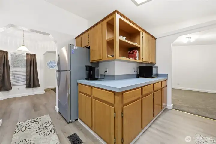 View of kitchen with breakfast nook to the left, and dining room to the right.