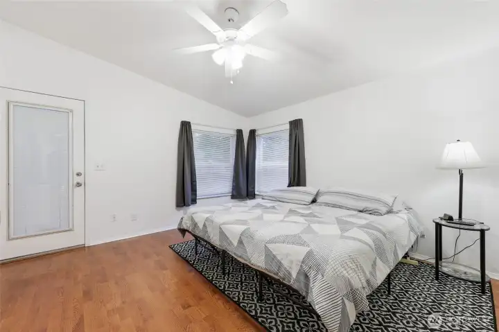 Primary bedroom with door to back yard.