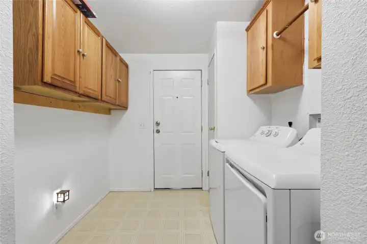 Laundry room with exit door to side of house. Newer appliances.