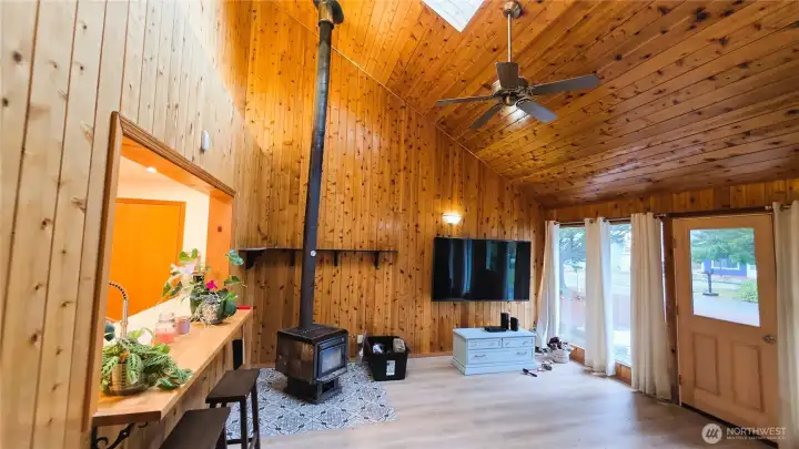 Large family room with wood stove and ceiling fan