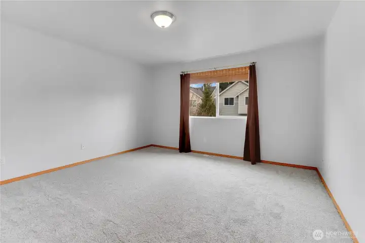 Primary bedroom with walk in closet, new carpet, and en-suite bathroom!