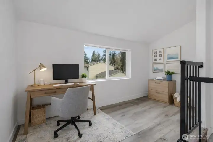 This photo is virtually staged. This upstairs room with a closet could be used as an an office or bedroom and can be accessed from inside or outside.