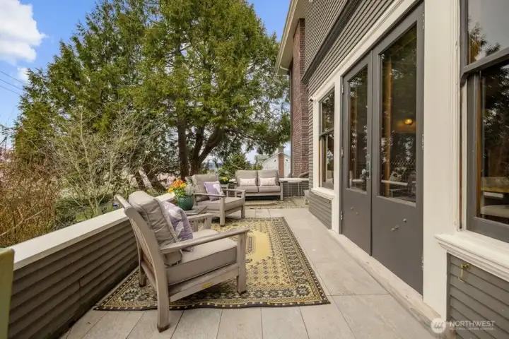 North side deck is elevated above the street to create privacy The floor was resurfaced with stone for improved drainage.