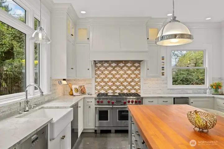 Professional grade appliances, Wolf range with griddle, dual Miele dishwashers, Sub-Zero refrigerator, under counter microwave and wine/drink refrigerator.