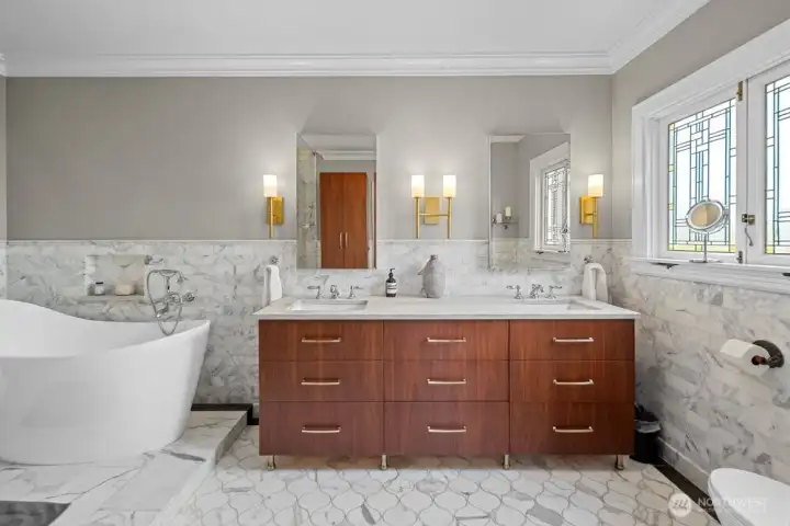 Wrapped in Calcutta and Carrera marble, heated floors, double sink vanity, volcanic limestone soaking tub and steam shower.