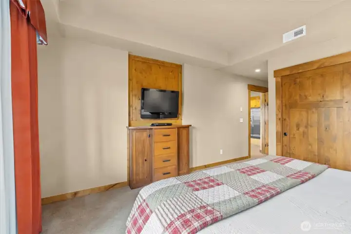 Wall-mounted television above built-in cabinet