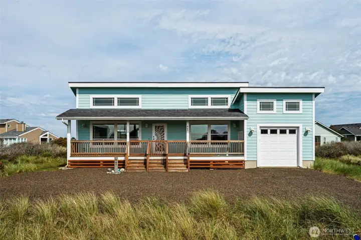 Dreaming of a Beach Cottage? Come check this one out! This is the front of home, lovely covered front porch, plenty of room to park in driveway, plus an attached one-car garage and a fully-fenced back yard! Short walk to jetty & beach!