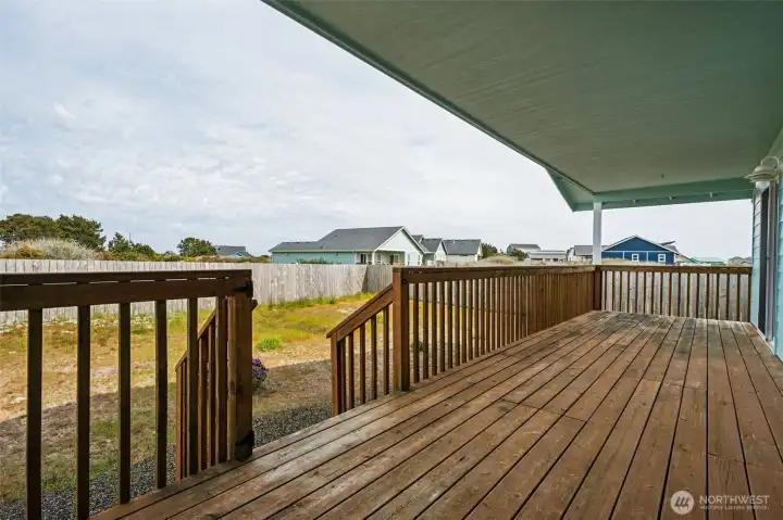 Relax on the covered back porch. The back yard is a sandy, blank slate which you may add to or leave as it is. It's very low maintenance.