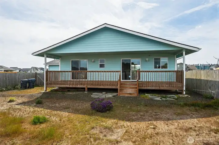 The sliding glass door on the left leads to the primary bedroom, the one on the right leads to the kitchen.