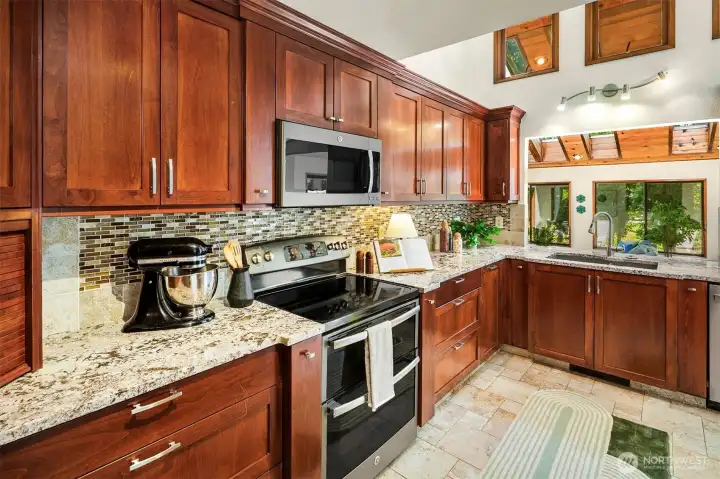 Gorgeous kitchen upgrades and the pass through looks out to the sunroom. More transom windows mean that every space is full of light!
