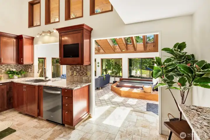 From the kitchen you step down into your sunroom and soak up the warmth, even on a chilly day! Brand new hot tub and surround stay!