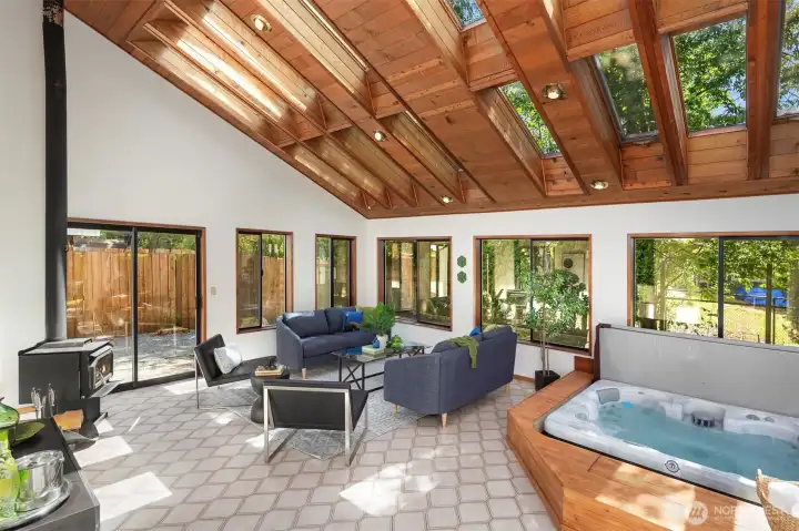 The sun room is full of light any time of year and the brand new hot tub will keep you warm every day of the year! Or turn it down for a cool dip in the summer! Real tile floors are classy and beautiful. The wood stove keeps it cozy when needed! This home is an entertainer's dream!