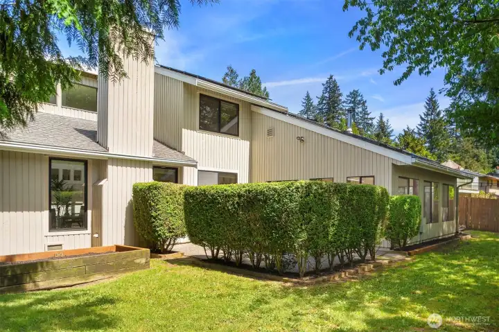 A view from the backyard. The hedge provides a lovely privacy shield for outside dining or socializing!