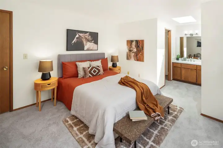 The main floor primary suite has a walk in closet and toilet room. It's spacious and light. The skylight makes natural light available for your morning routine!