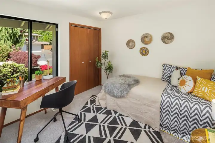 This is one of the three main floor bedrooms. This one looks out to the mature landscaping in the front and has a nice sized closet.