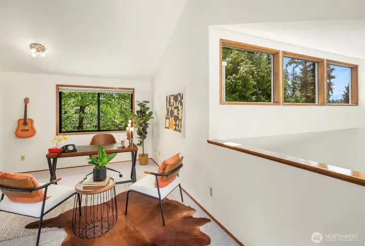 At the top of the stairs is an incredible bonus space (with a closet!). You can see the transom windows that overlook the living room! Green views from every window!