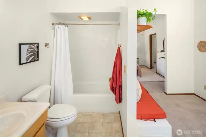 Upstairs primary bathroom suite with built in seating and massive closet!